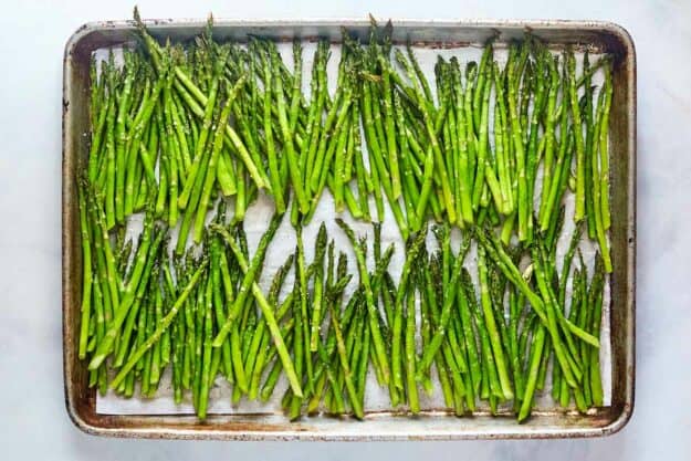 Roasted asparagus on a baking sheet.