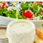 Dill pickle ranch dressing in a glass jar and on a salad.