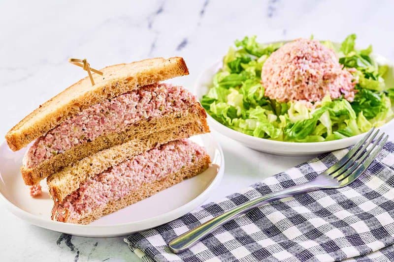 Ham salad sandwich, ham salad on top of lettuce, and a fork.