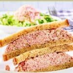 Homemade ham salad sandwich on a white plate.