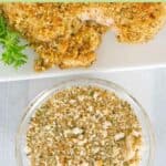 Overhead view of homemade Italian seasoned bread crumbs in a bowl next to a platter.