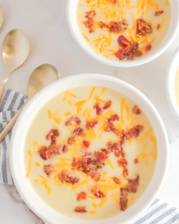 Overhead view of copycat La Madeline country potato soup in two bowls.