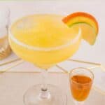 Homemade Olive Garden Italian margarita and amaretto in a cordial glass next to it.