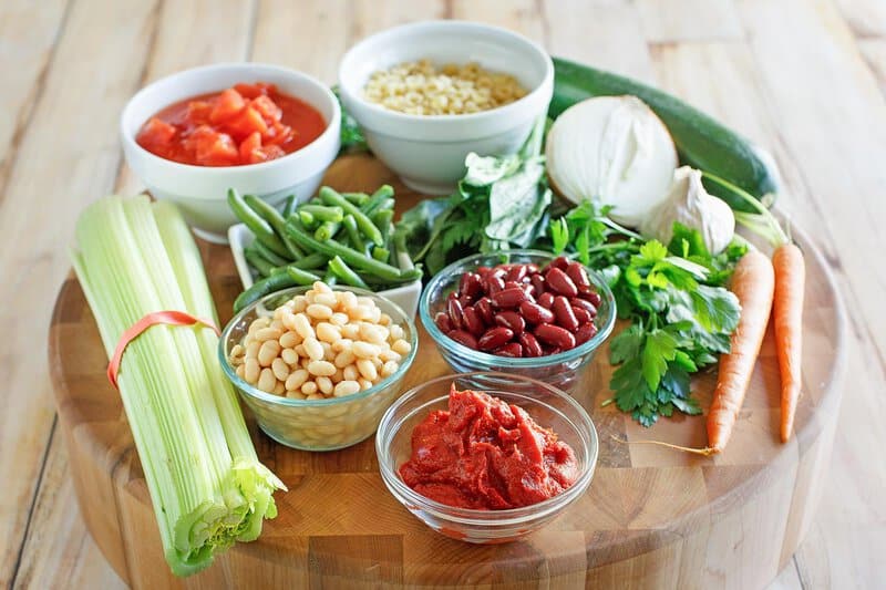 Copycat Olive garden minestrone ingredients on a wood board.
