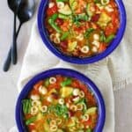 Overhead view of copycat Olive Garden minestrone soup in two bowls.