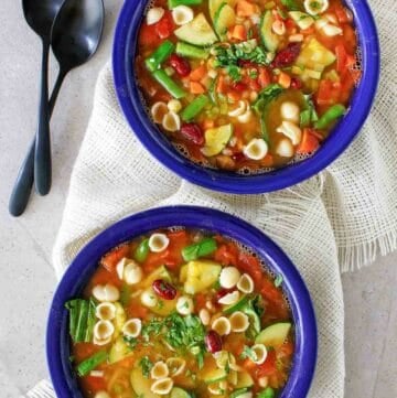 Overhead view of copycat Olive Garden minestrone soup in two bowls.