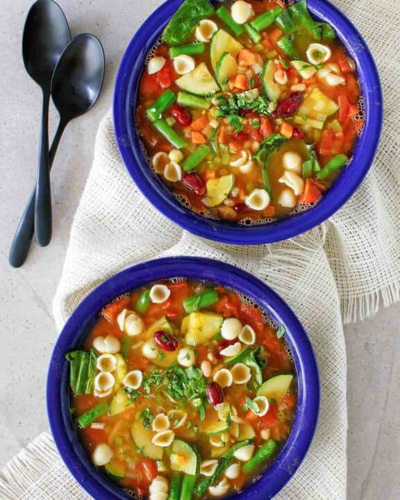 Overhead view of copycat Olive Garden minestrone soup in two bowls.