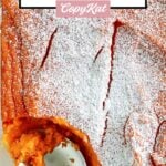 Overhead view of copycat Piccadilly carrot souffle and a spoon in a baking dish.