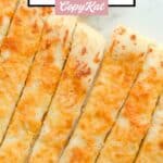 Several homemade Pizza Hut cheese sticks on a marble surface.