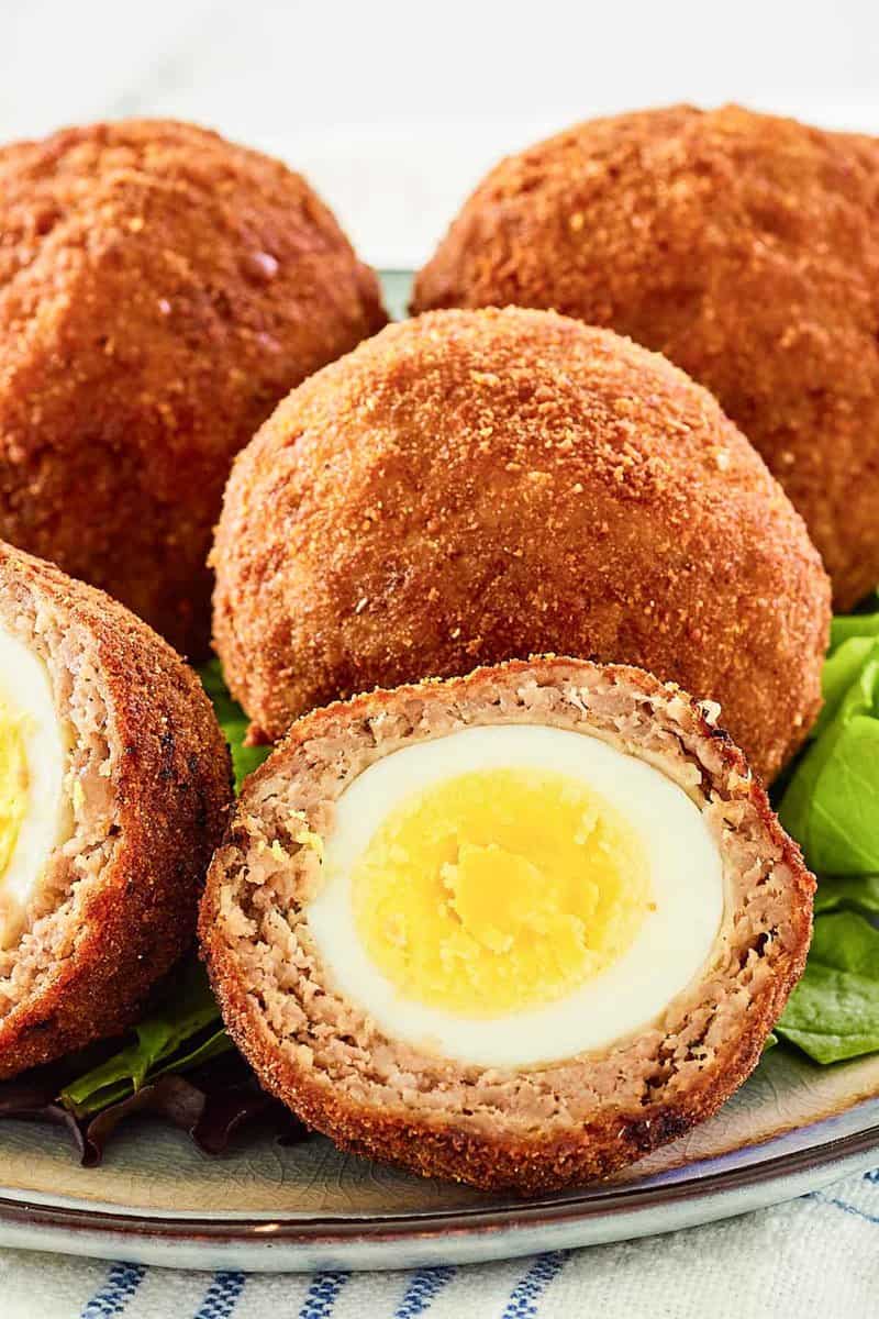 Homemade Scotch eggs on a plate.