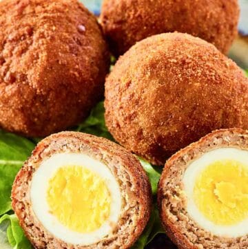 Scotch eggs on a plate.
