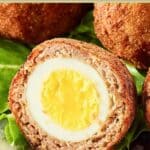 Closeup of a Scotch egg cut in half.