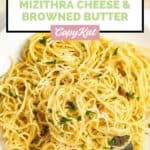 Closeup overhead view of homemade spaghetti with mizithra cheese and browned butter.
