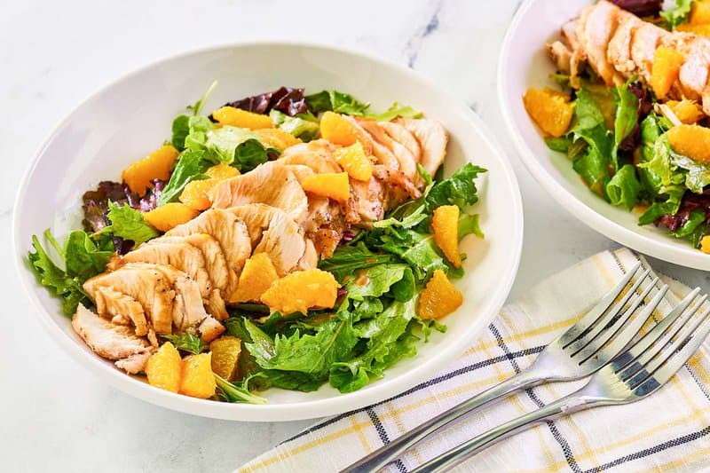 Bowls of copycat TGI Friday's mandarin orange salad with chicken.