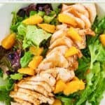 Closeup overhead view of homemade TGI Friday's mandarin orange salad with chicken.