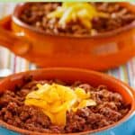 Homemade Wick Fowler 2 alarm chili topped with shredded cheese.