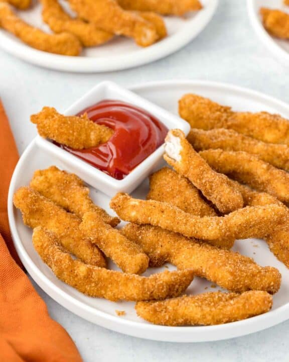 Copycat Burger King chicken fries and a small cup of ketchup on a plate.