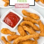 Homemade Burger King chicken fries and a small cup of ketchup on a plate.