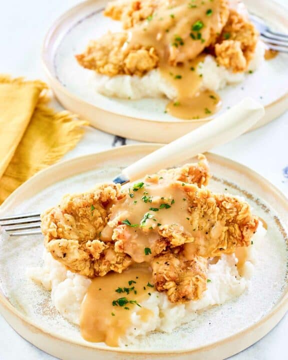 Copycat Cracker Barrel fried chicken tenders on two plates.