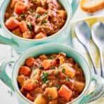 Crockpot beef stew with potatoes and carrots in two bowls.