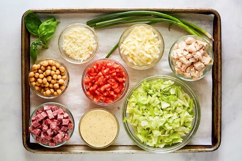 Copycat Cucina Cucina chopped salad ingredients on a tray.