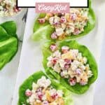 Three servings of fruity chicken salad on a platter.