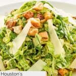 Homemade Houston's spicy Caesar dressing and salad on a white plate.