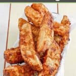 Homemade jojo potato wedges in a serving basket lined with parchment paper.