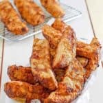 Homemade jojo potato wedges in a basket and on a wire rack.