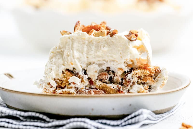 Copycat Luby's butternut brownie pie slice garnished with chopped pecans.