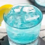 Homemade Olive Garden Blue Amalfi cocktail garnished with a lemon wedge.