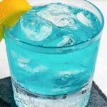 Homemade Olive Garden Blue Amalfi cocktail garnished with lemon.
