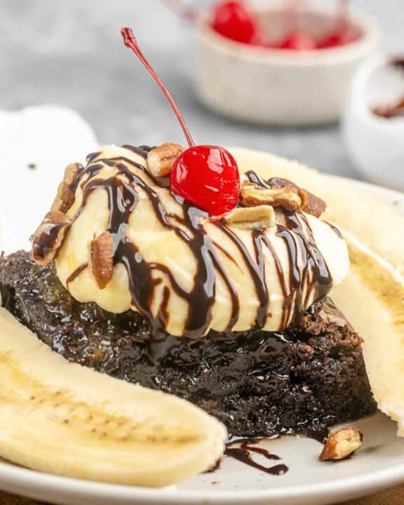 Copycat Olive Garden brownie banana funtastico and a bowl of cherries.