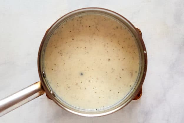 White sauce for carbonara in a saucepan.