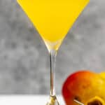 Copycat Olive Garden mango martini and a mango.