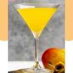 Homemade Olive Garden mango martini on a coaster and a mango.