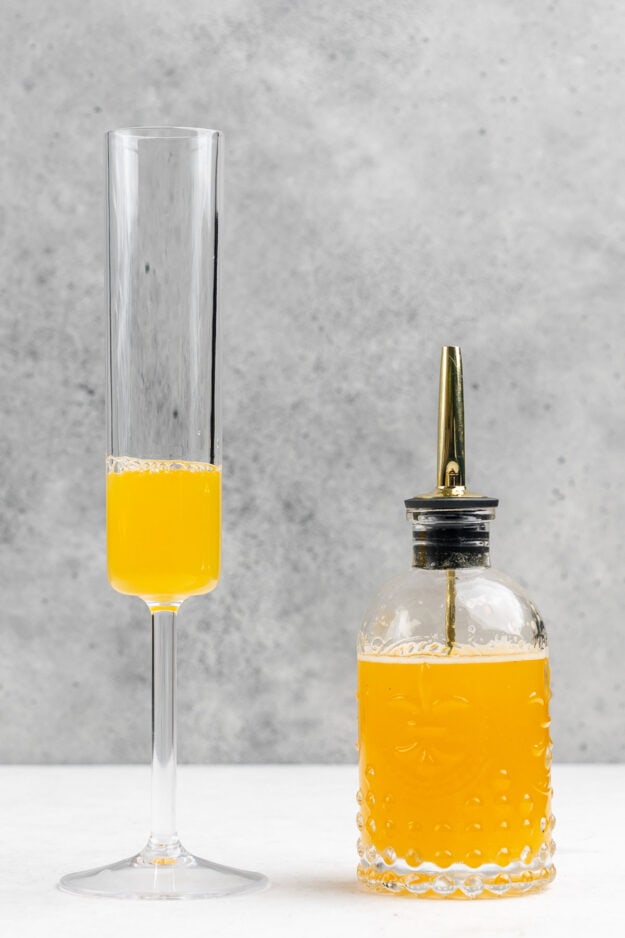 Peach nectar in a champagne flute.