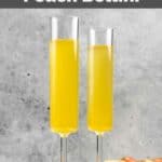 Two homemade Olive Garden peach bellini drinks and peaches behind them.