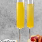 Homemade Olive Garden peach bellini in two champagne flutes.