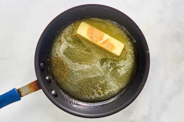 Butter and garlic powder in a skillet.