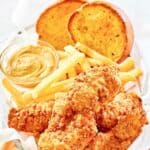 Homemade Whataburger chicken strips, dipping sauce, fries, and toast.