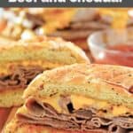 Copycat Arby's beef and cheddar sandwiches and a bowl of Arby's sauce.
