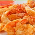 Beer battered shrimp on a plate.
