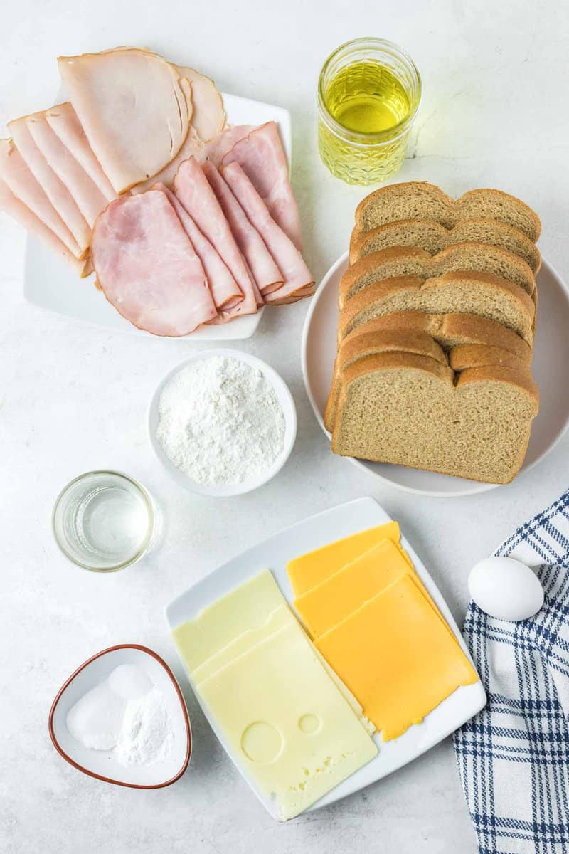 Copycat Bennigan's Monte Cristo sandwich ingredients on a marble surface.
