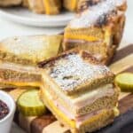 Copycat Bennigan's Monte Cristo sandwich slices on a wood board.