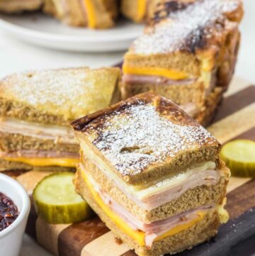 Copycat Bennigan's Monte Cristo sandwich slices on a wood board.