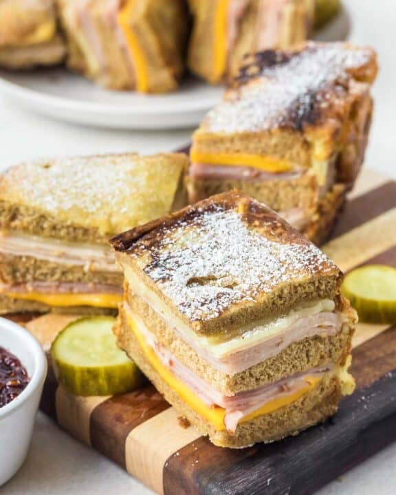 Copycat Bennigan's Monte Cristo sandwich slices on a wood board.