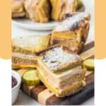 Homemade Bennigan's Monte Cristo sandwich slices on a wood board.