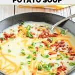 A bowl of homemade Bennigan's baked potato soup with toppings.