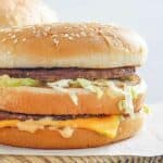 Homemade McDonald's big mac on parchment paper.